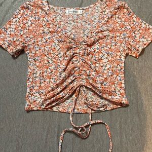 Room Mates light red, red, blue, green, and white flower shirt